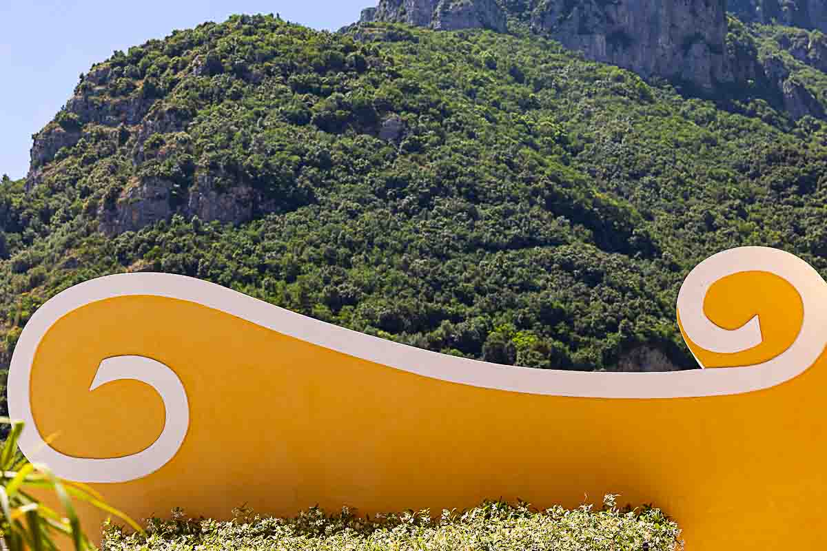 geometrical architectural elements photographed before the green hills of the town mountains