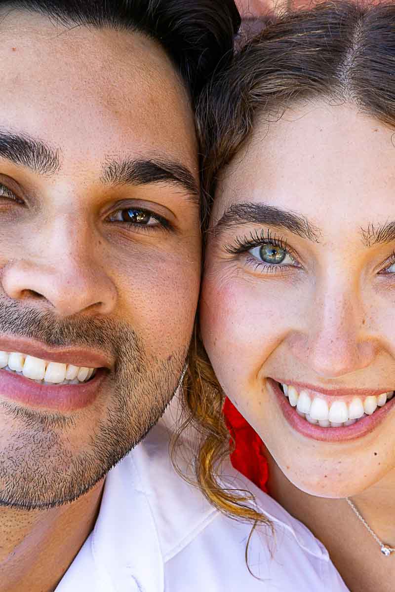 Artistic close-up portrait of the couple’s smiling faces, highlighting their joyful expressions during a romantic photo session