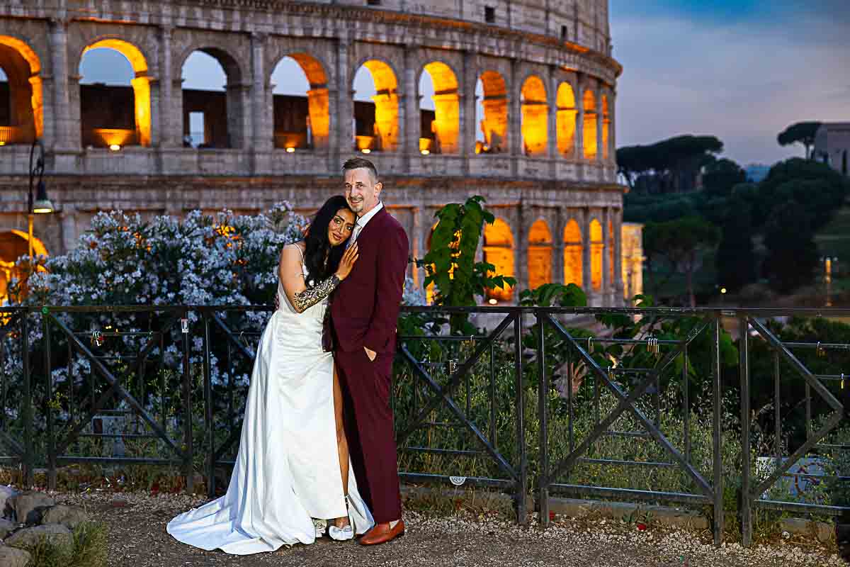 Posed snapshot of a couple just married in Italy and taking wedding photos at Rome's Coliseum 