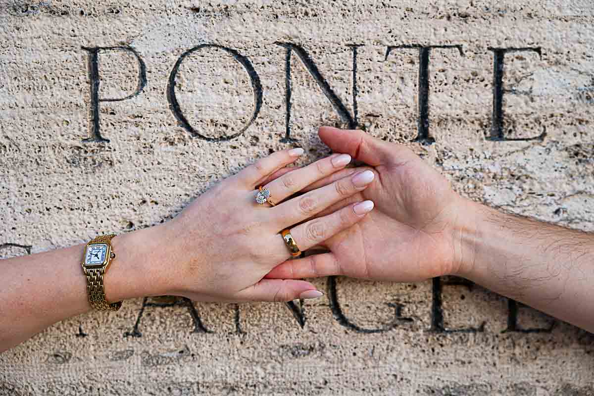 Unique and creative engagement picture of a couple's hand holding onto each other with the engagement ring 