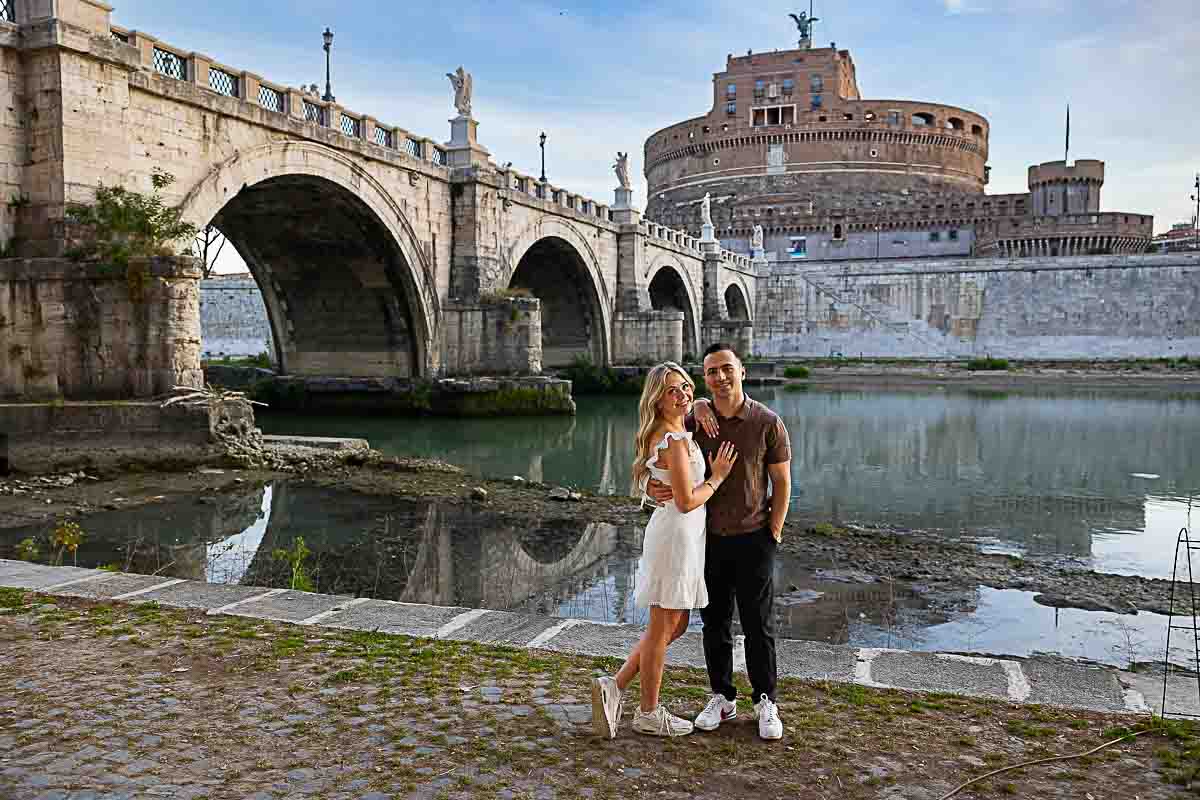 Standing underneath the bridge taking couple photography after proposing on the bridge at dawn 