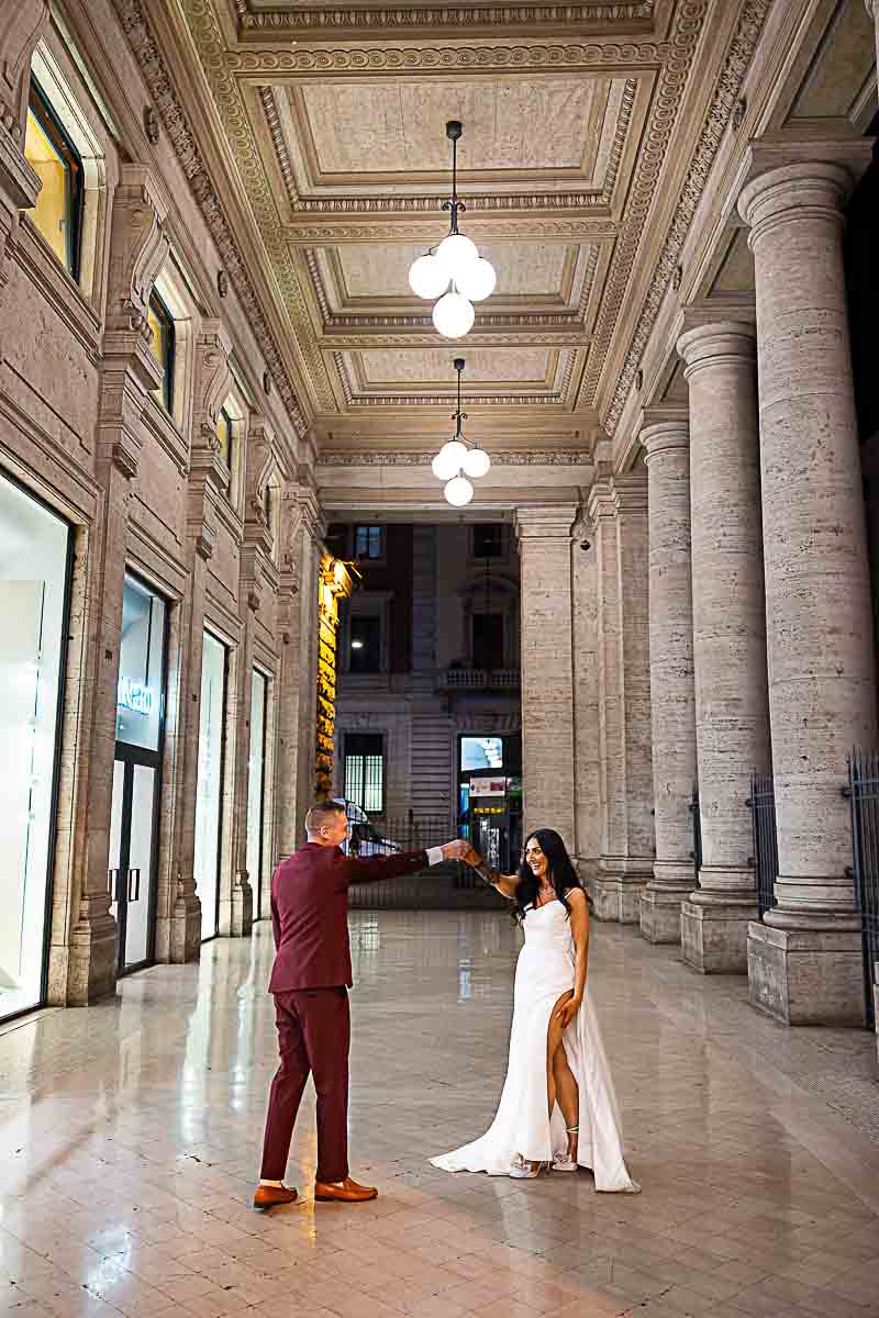 Dancing in the street lights of a tall portico found in the roman streets 