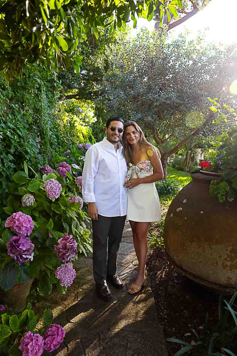 Portrait photography lifestyle photo shoot of a just engaged couple taken in a garden with flowers and vegetation Romantic Proposal Capri