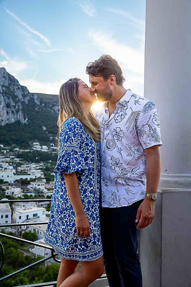 Couple portrait in love kissing at sunset during a photography session on the Capri island 