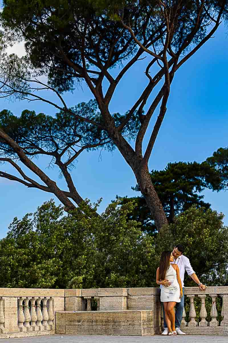 Standing underneath tall mediterranean pine trees posing for picture taking 