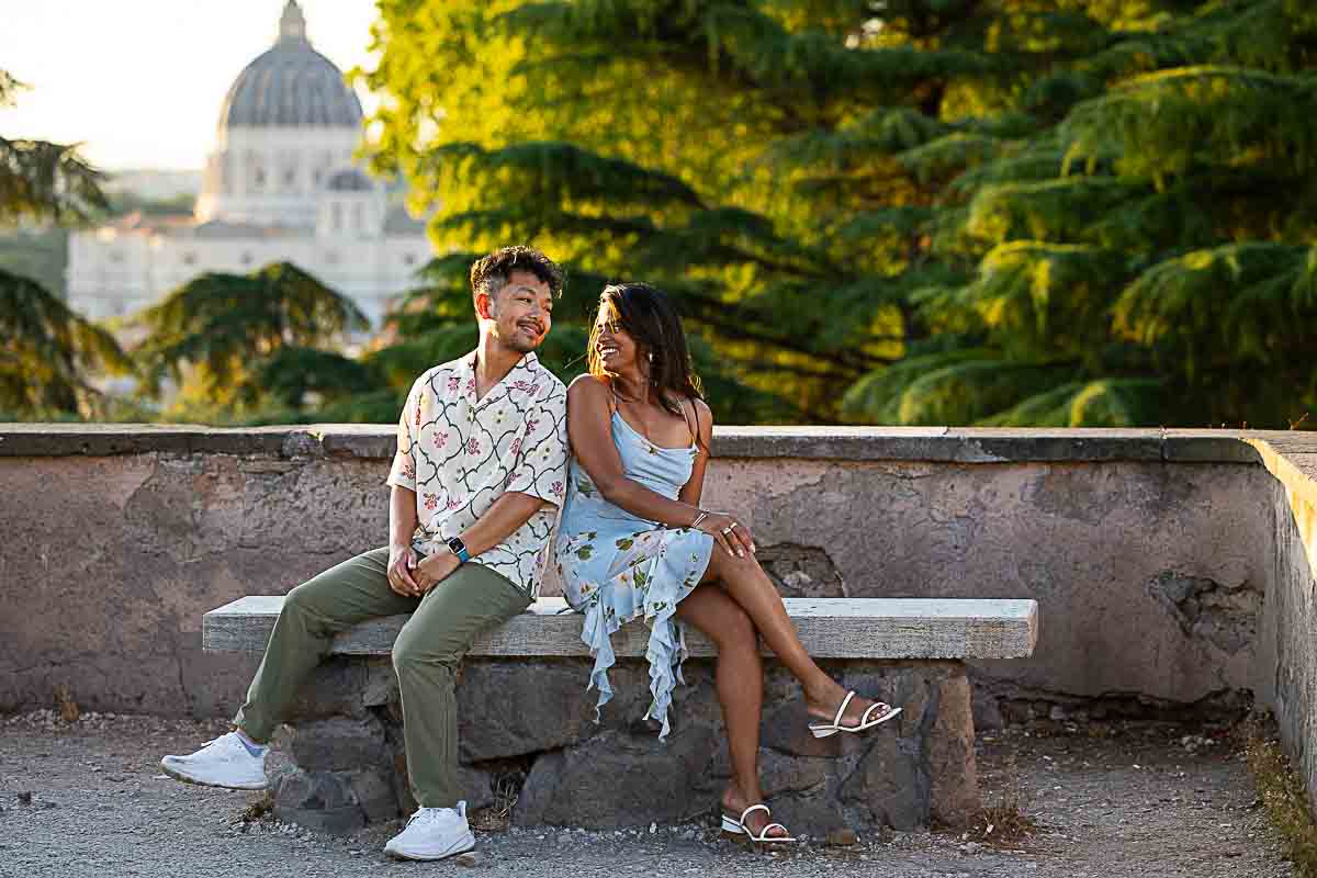 Sitting down on a bench while looking at each other during a photoshoot in the Eternal city 