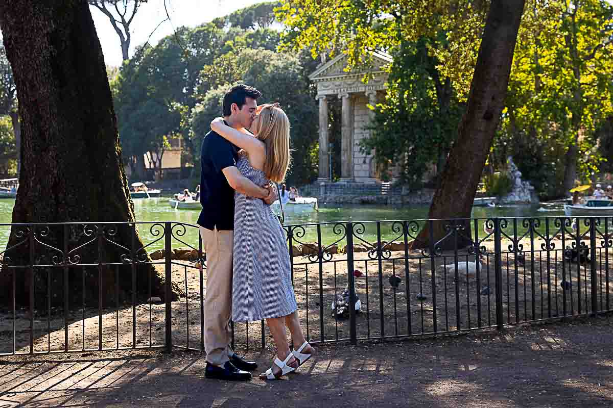 Lots of joy and happiness for the newly engaged couple kissing and embracing after the biq question and the faithful yes 