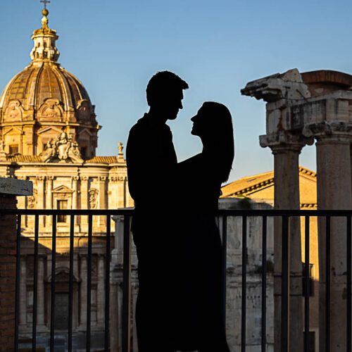 Silhouette image of a couple looking at each other during a photoshoot in Rome over ancient ruins