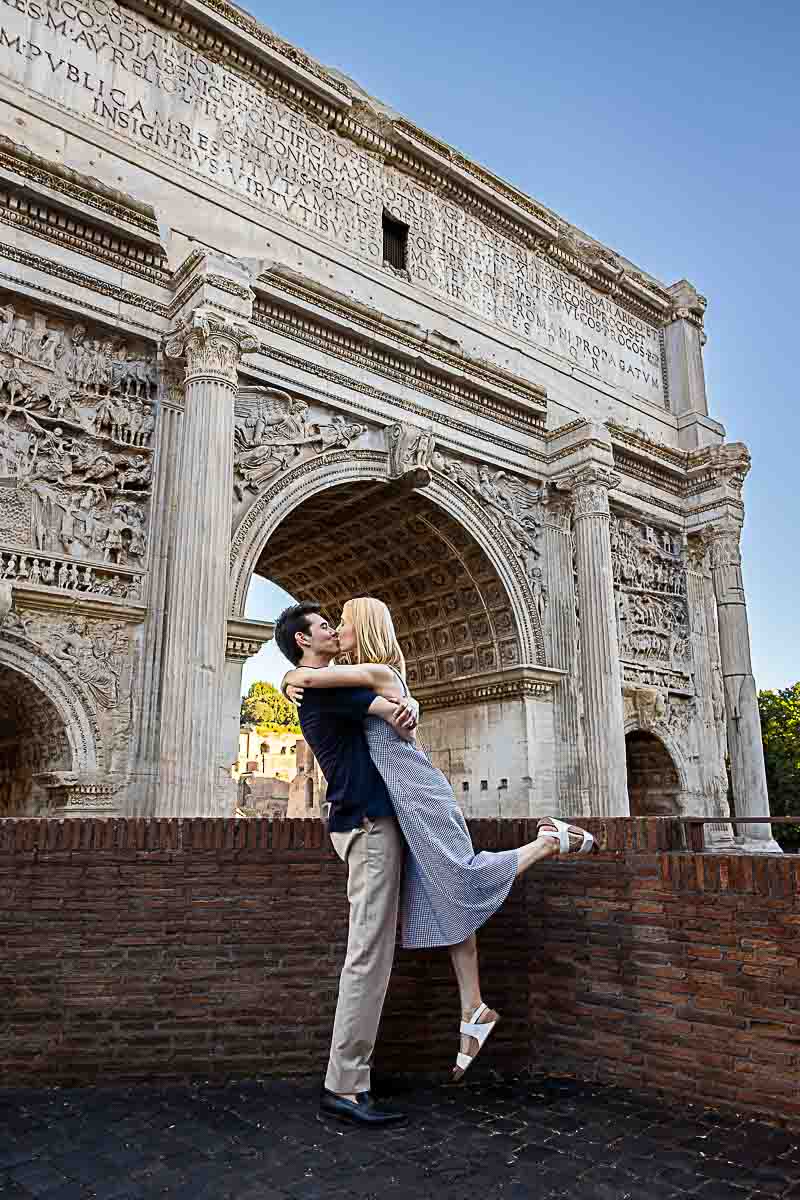 Taking pictures before the arch of Septimius Severus found in the forum of Rome 
