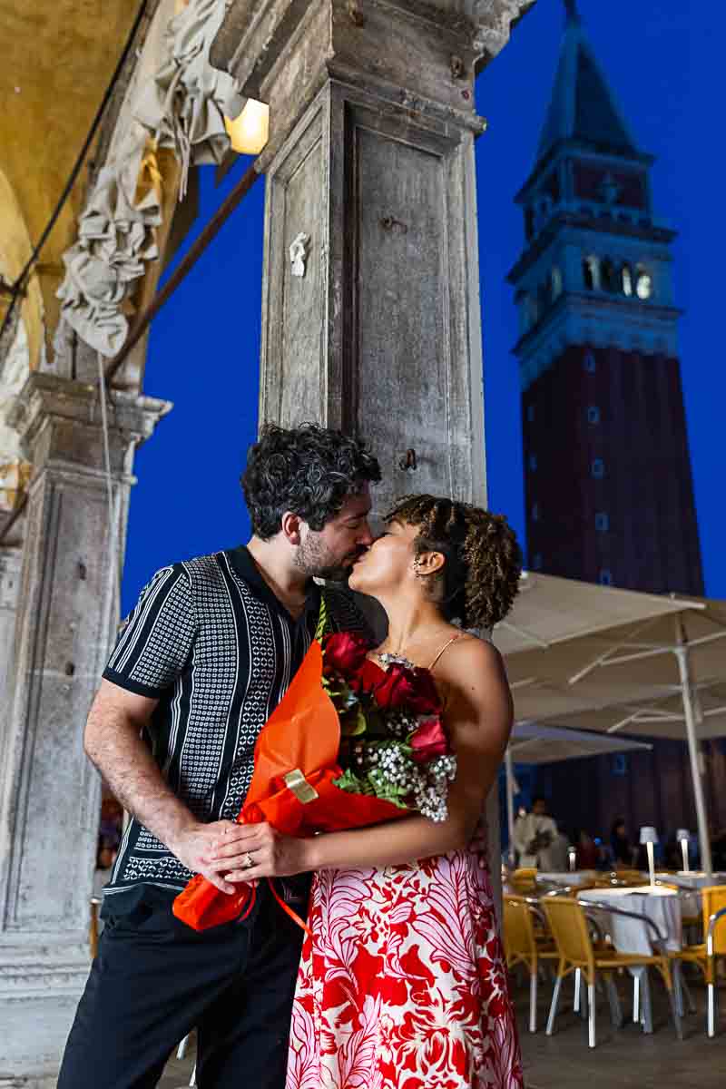 Romantic kiss under the bell tower 