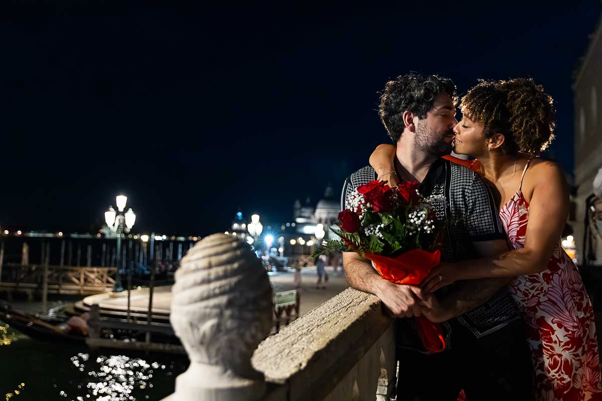 Romance photographer session in Venice Italy during a photoshoot with a couple at night with street light 