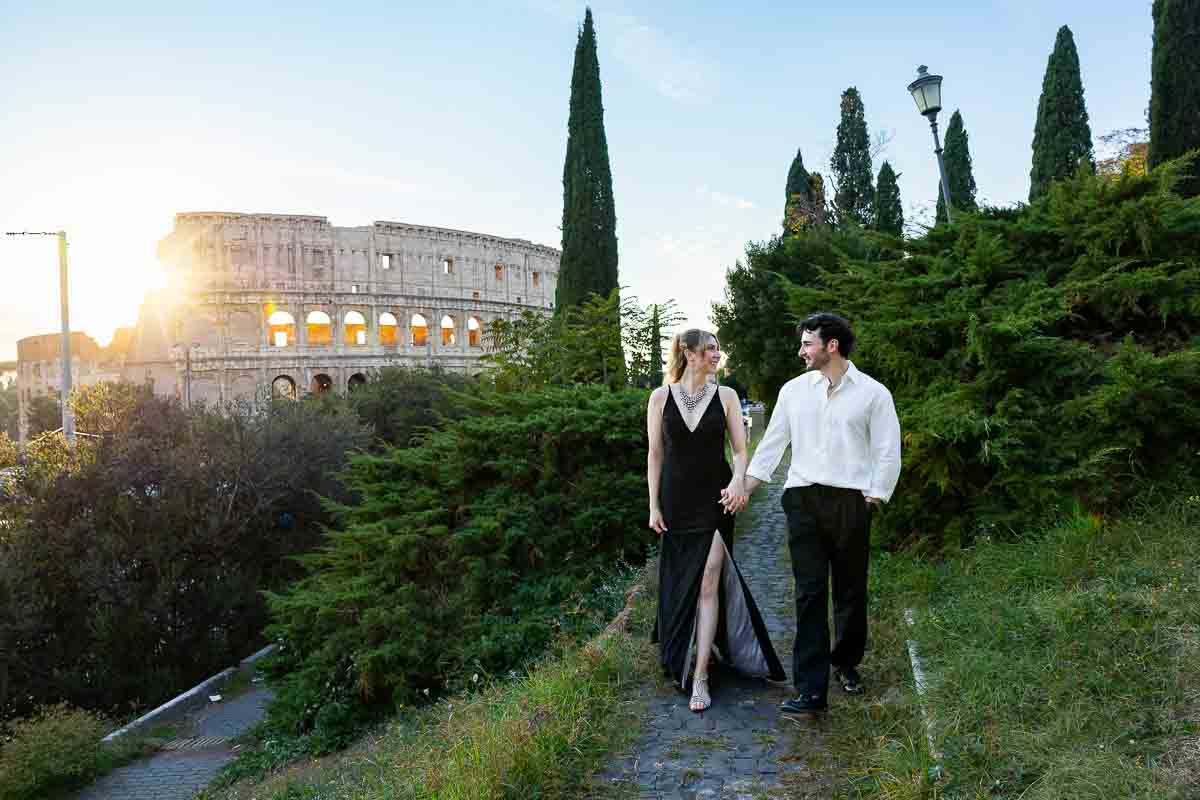 Walking together while holding hands and moving forward towards the camera and the picture taking