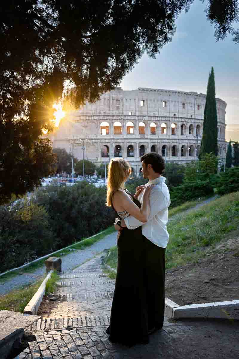 Standing together admiring the roman skyline view colosseum at sunset