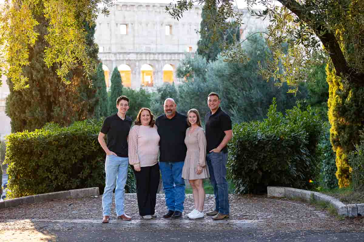 Family pictures taken in front Colosseum from a nearby park