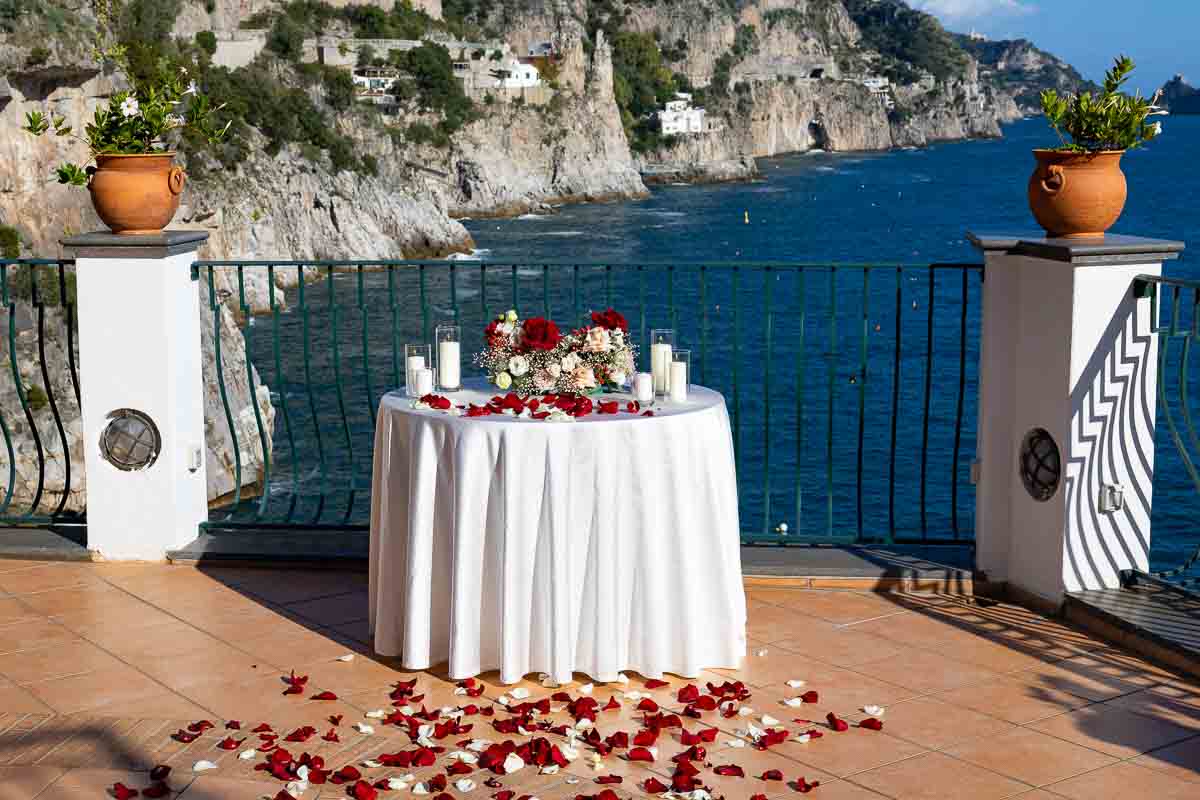 Table set up for the perfect moment to ask the big question with flowers roses candles and petals 