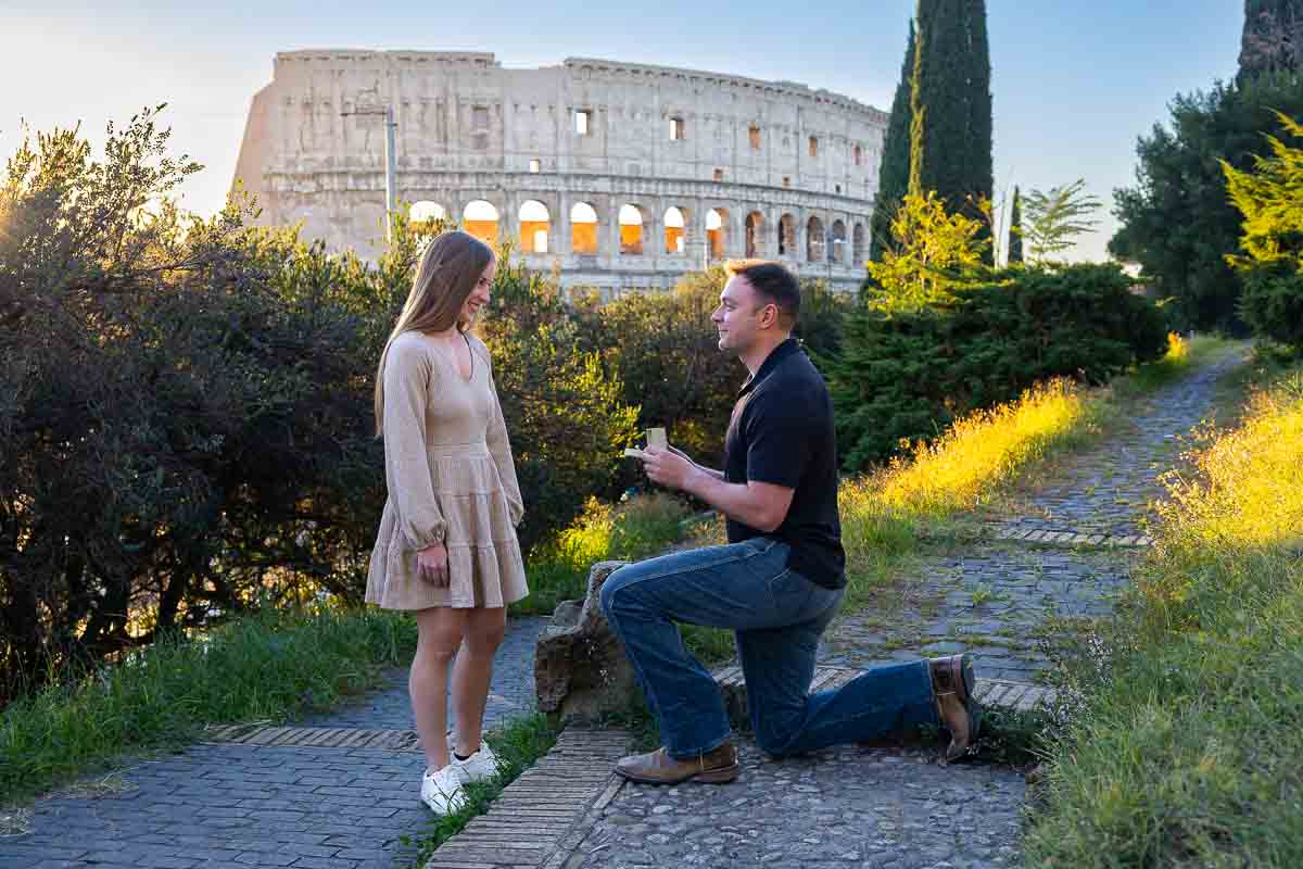 Kneeling down for a surprise proposing moment in Rome during the golden hour Coliseum