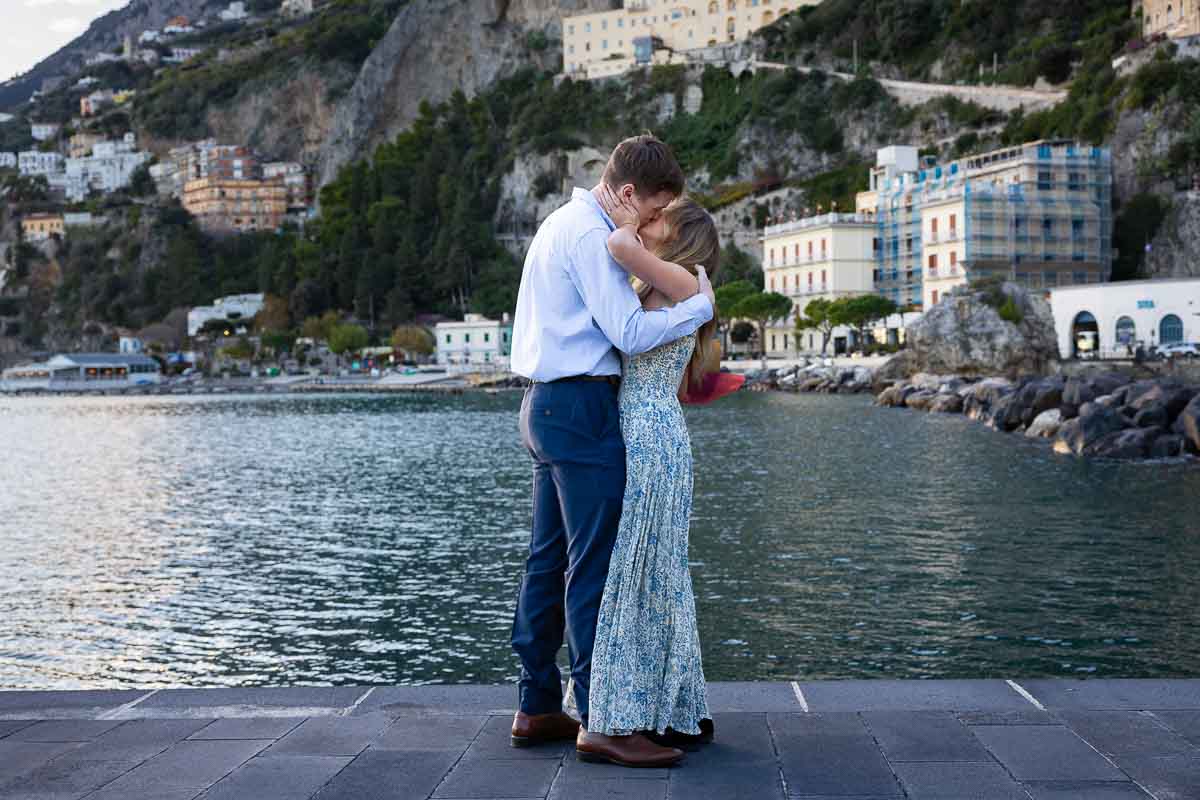 The moment in which she said yes as he proposed then a kiss taking pictures on a photoshoot and photography session 