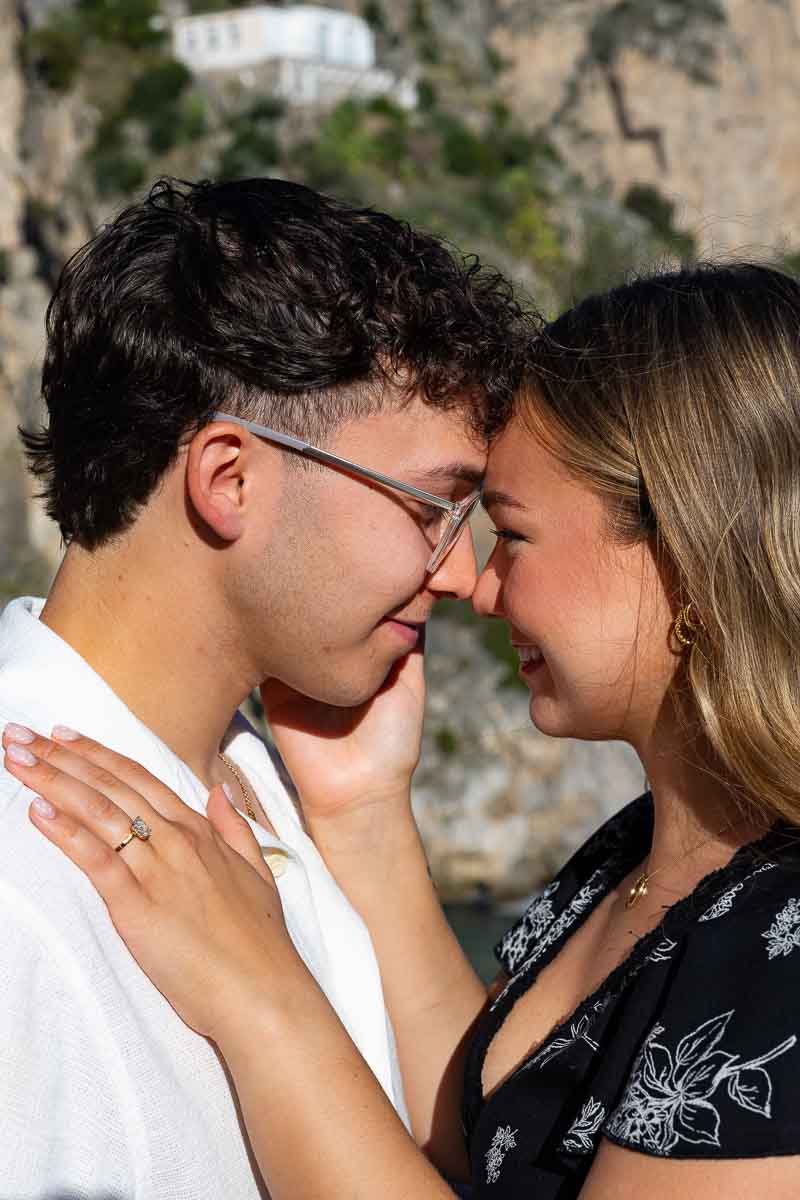 Close up image taken by a nearby photographer of a couple together with the diamond ring 