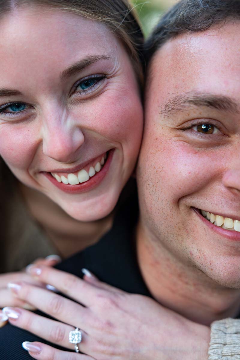 Close up facial portrait of him and her with the diamond ring