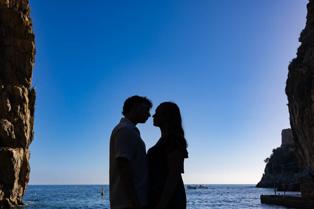 Silhouette artistic photography of a couple next to one another in ina image with blue sky