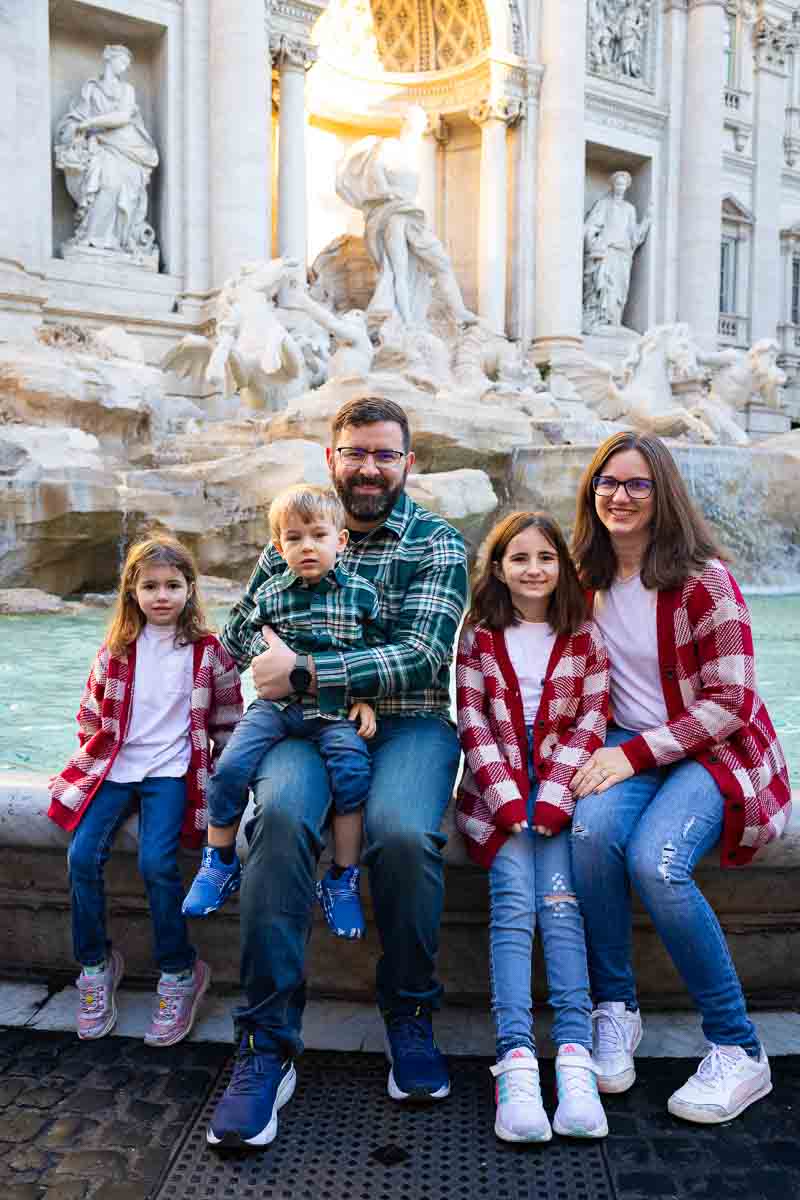 Sitting down on the edge of the water group snapshot vacation photography -- Trevi Fountain Family Photographer