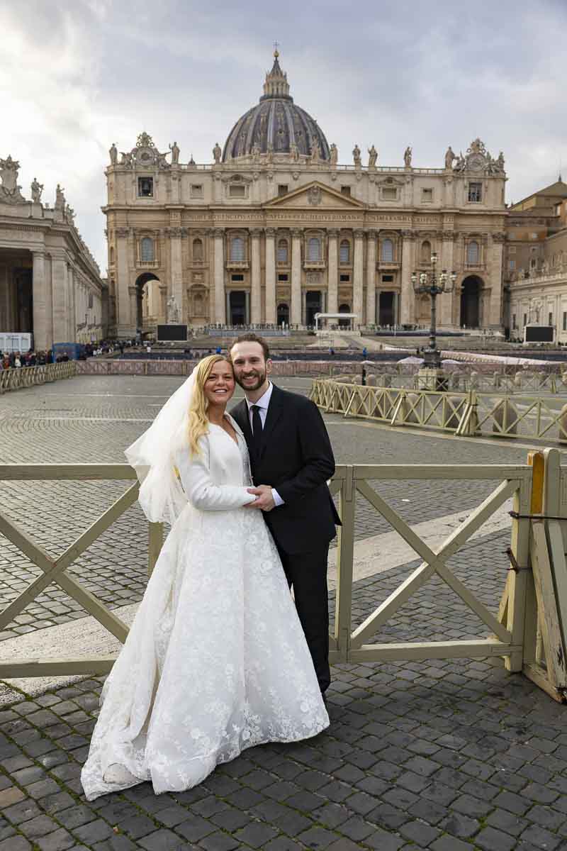 Posed portrait picture of a couple taken in front of the basilica in the main square while taking photographer's pics