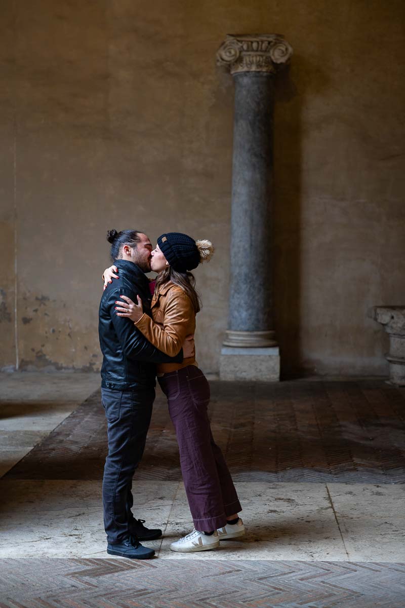 Kissing right after he proposed front of romanesque column artifact 