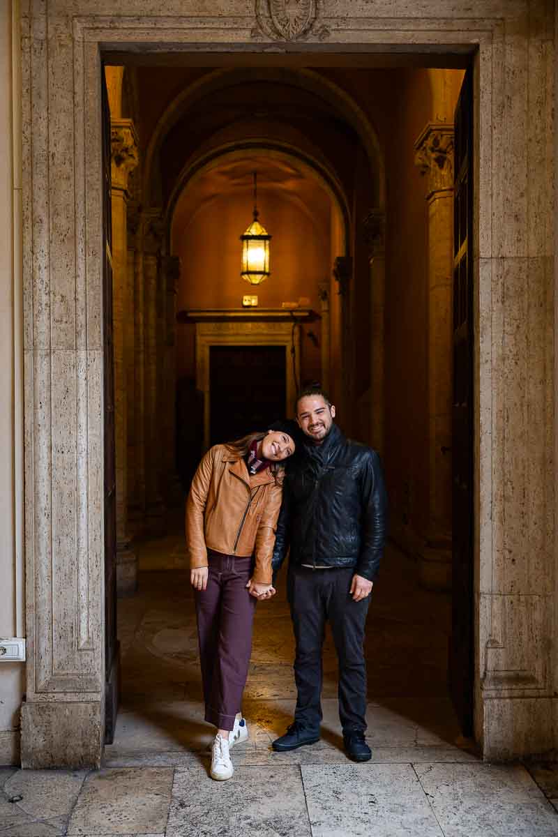 portrait picture of a couple just newly engaged photographed during a photo shoot by a door entrance to 