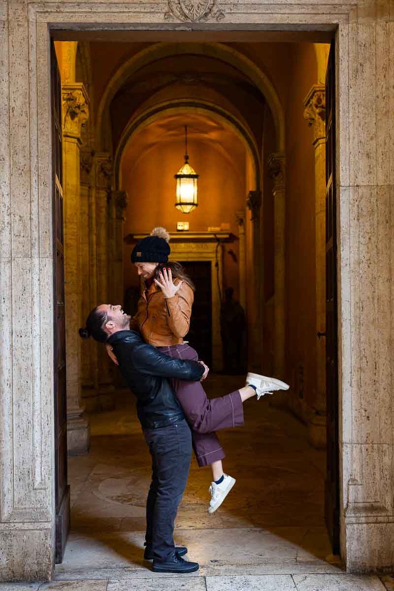 Jump up in the air to shot the engagement ring during a photoshoot photography session in front of a scenic doorway