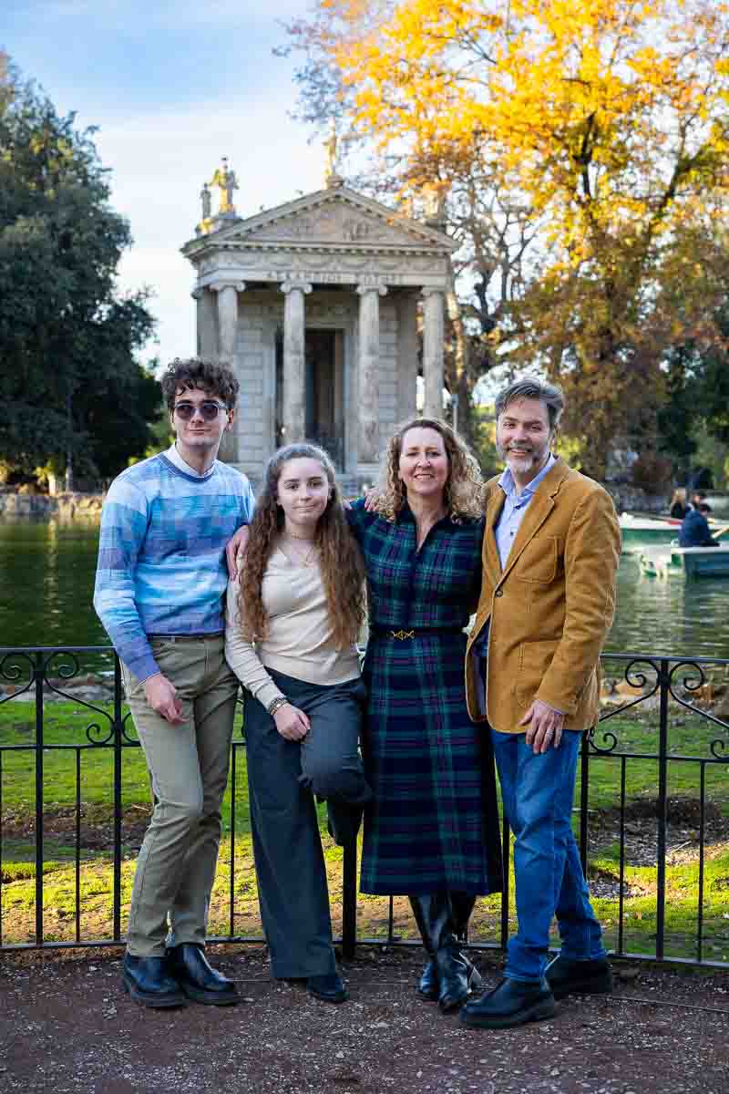Posing for group shot standing together before the temple and the lake during a photoshoot photographer session