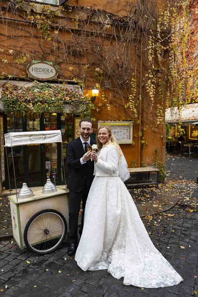 Italian gelato posing in front of store and cart while holding a cone in destination wedding images 