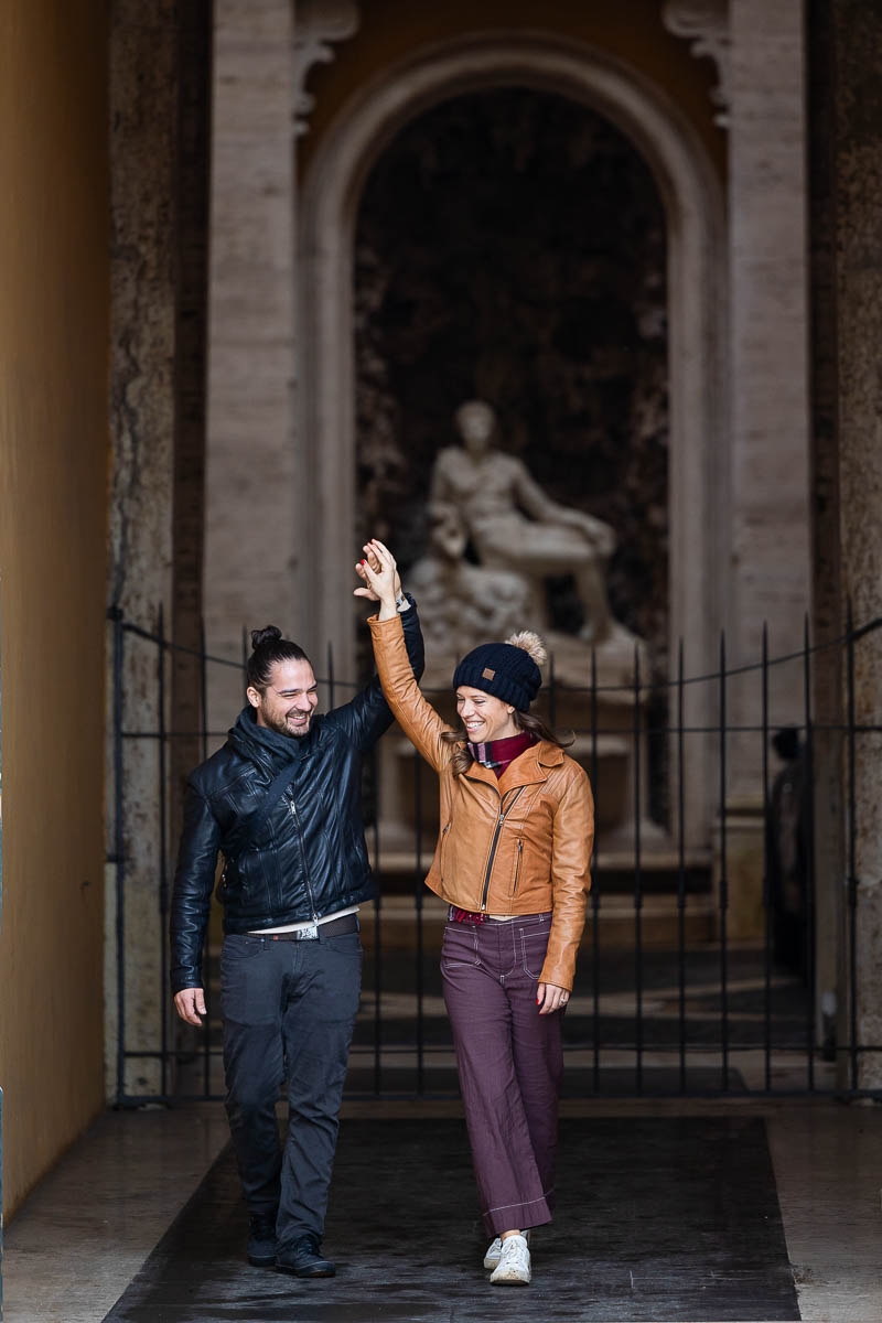 Dancing together while taking pictures a marble statue hand up in the air pose photography session