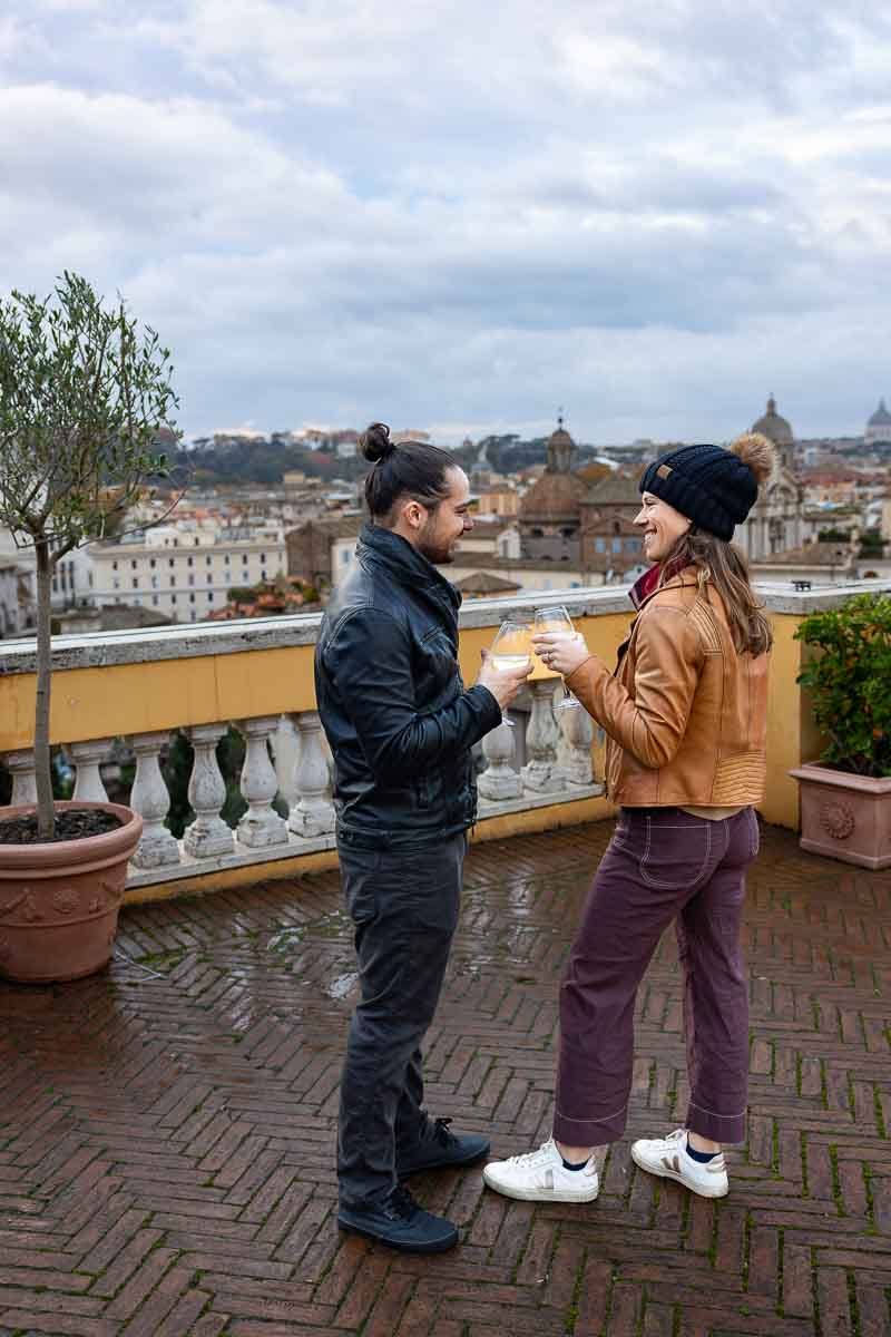 Toasting to each other while holding glasses with prosecco staring into eyes