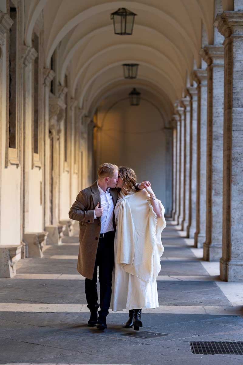 Walking under columns during a photo shoot in Italy passing under arches 