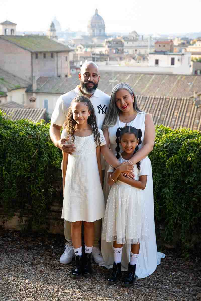 Parents and children photographed against the Roman skyline at sunset