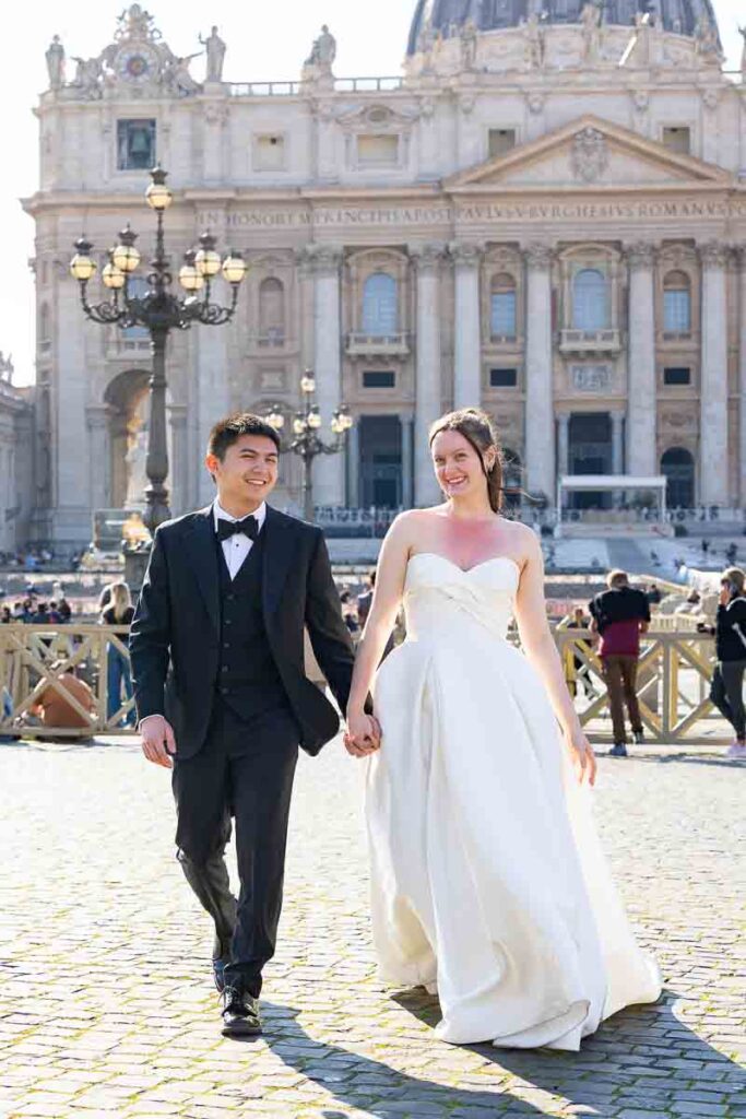 Candid walking shot of a happy couple in Saint Peter’s Square during their Rome photoshoot.