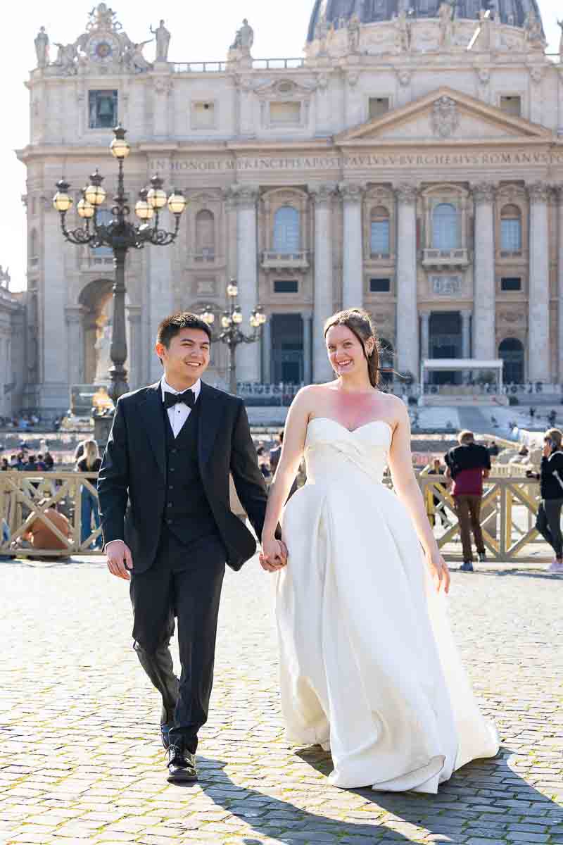 Candid walking shot of a happy couple in Saint Peter’s Square during their Rome photoshoot.