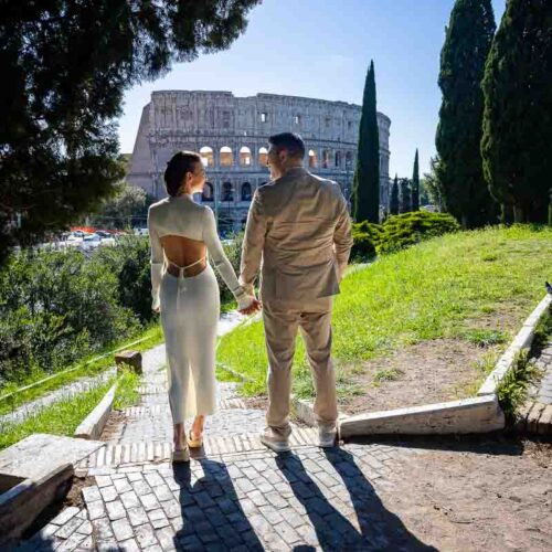 Holding hands and looking at each other while taking pictures during a photography session