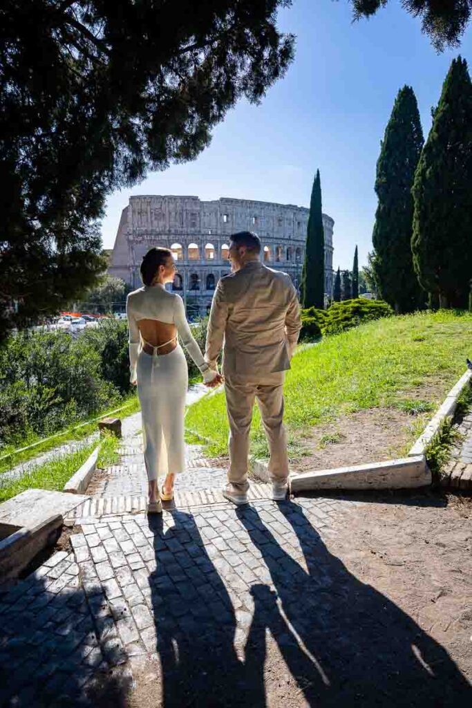 Holding hands and looking at each other while taking pictures during a photography session