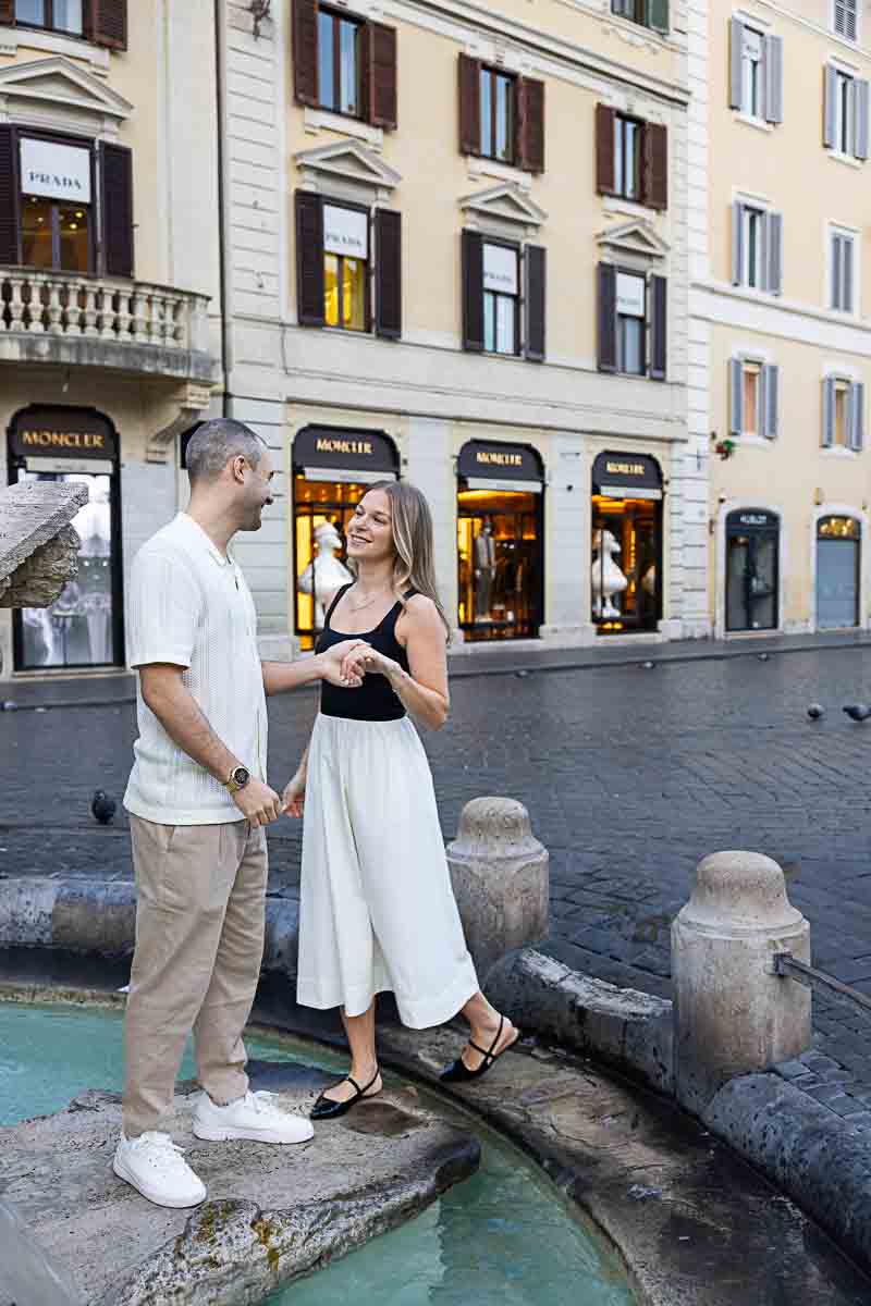 Couple stopping at the Barcaccia fountain, Piazza di Spagna