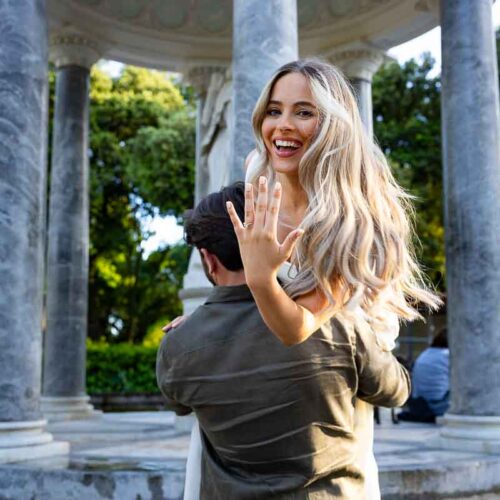 Showing the engagement ring to the professional camera while photo shooting at the Diana temple