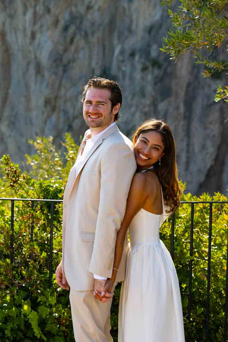 Standing next to one another during a photo session happily smiling 