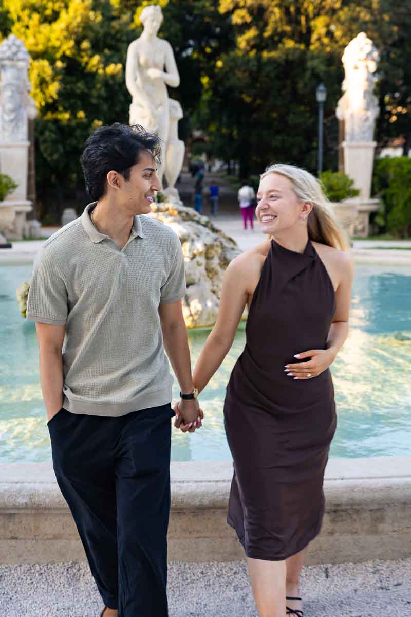 Having fun taking walking pictures during the engagement photography session with a professional photographer using documentary techniques to photograph