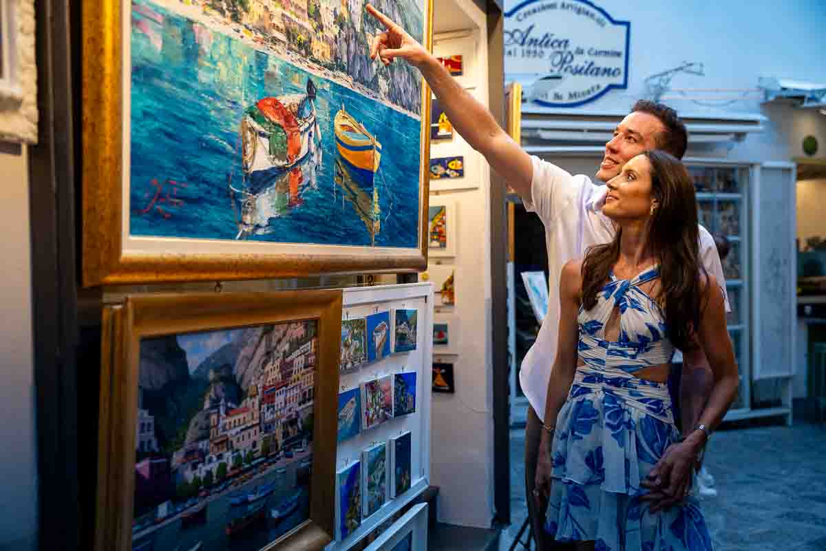Browsing and pointing at painting depicting seascape scenes 