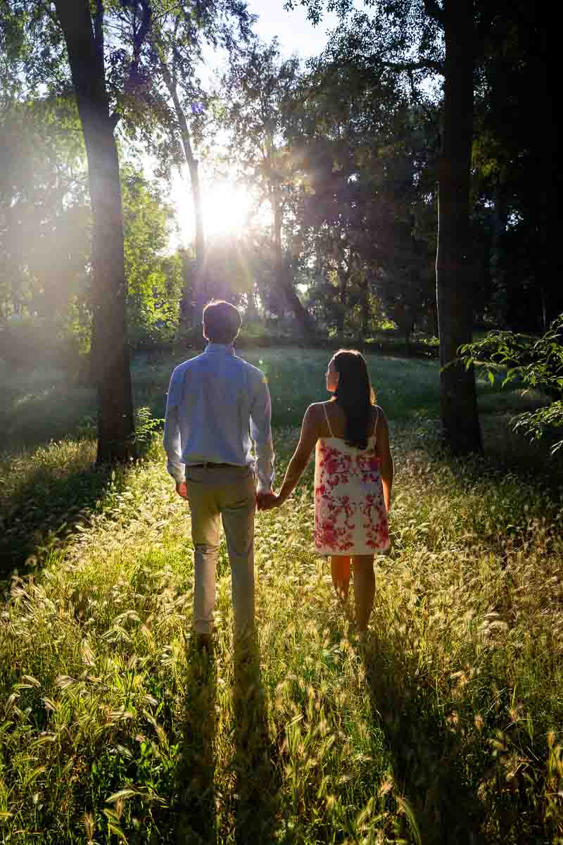 Walking together hand in hand into the setting sun creating long shadows 