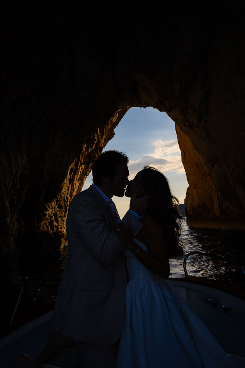 Final silhouette image of a couple kissing at sunset 