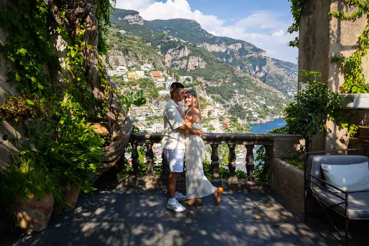 Newly engaged couple exploring the hillside streets together during a relaxed photography session, capturing natural moments after a private marriage engagement