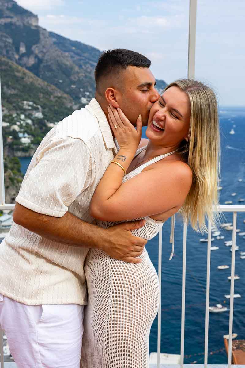 Close-up candid portrait of a smiling newly engaged couple enjoying a joyful moment together during their romantic couples photography session