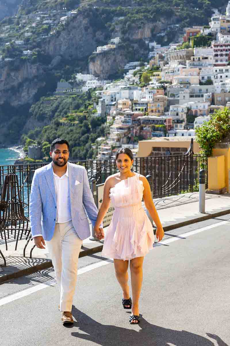 Strolling hand in hand along the winding coastal roads during a destination photo session.