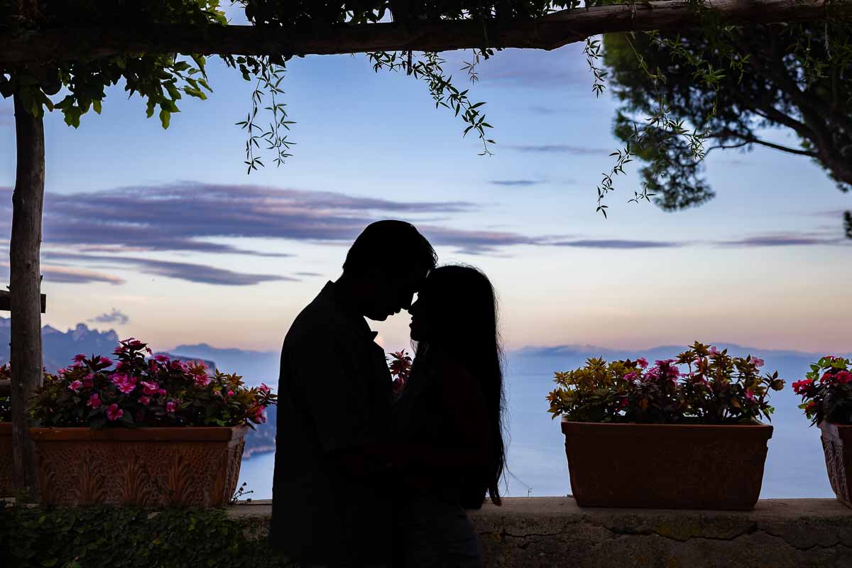 A masterfully composed silhouette portrait demonstrating advanced low-light photography mastery and creative framing at dusk.